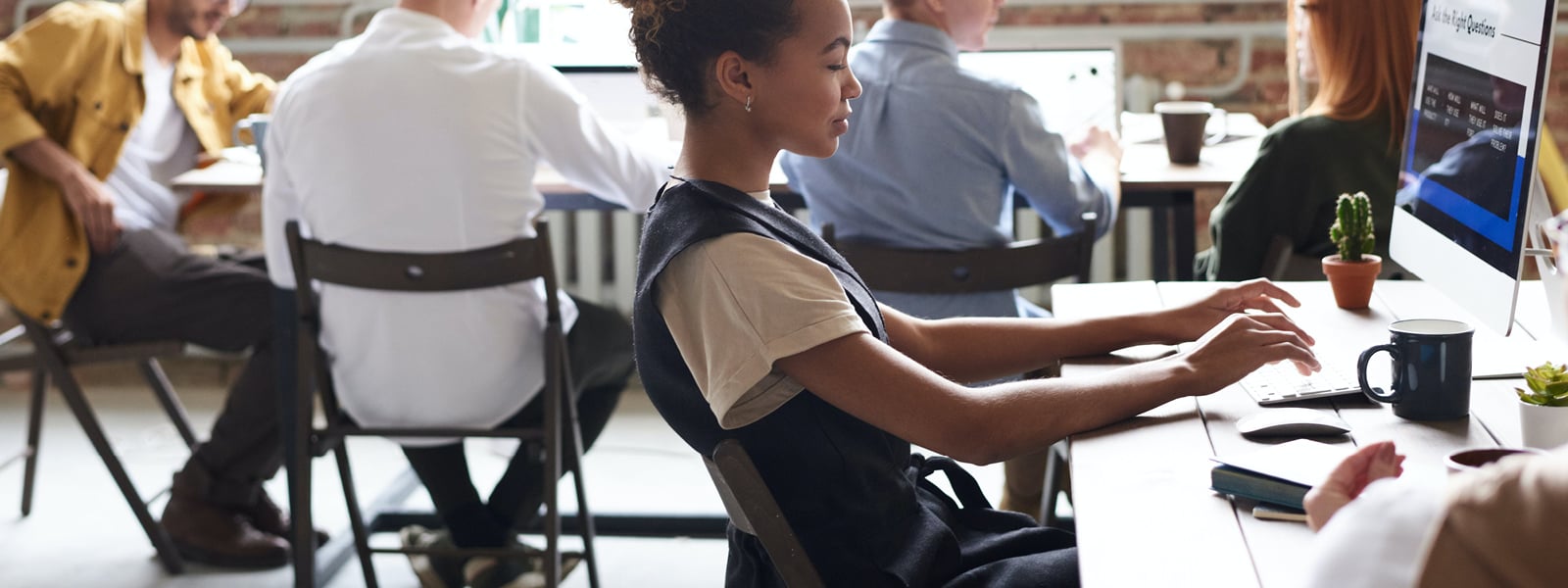 A student at a computer typing. 