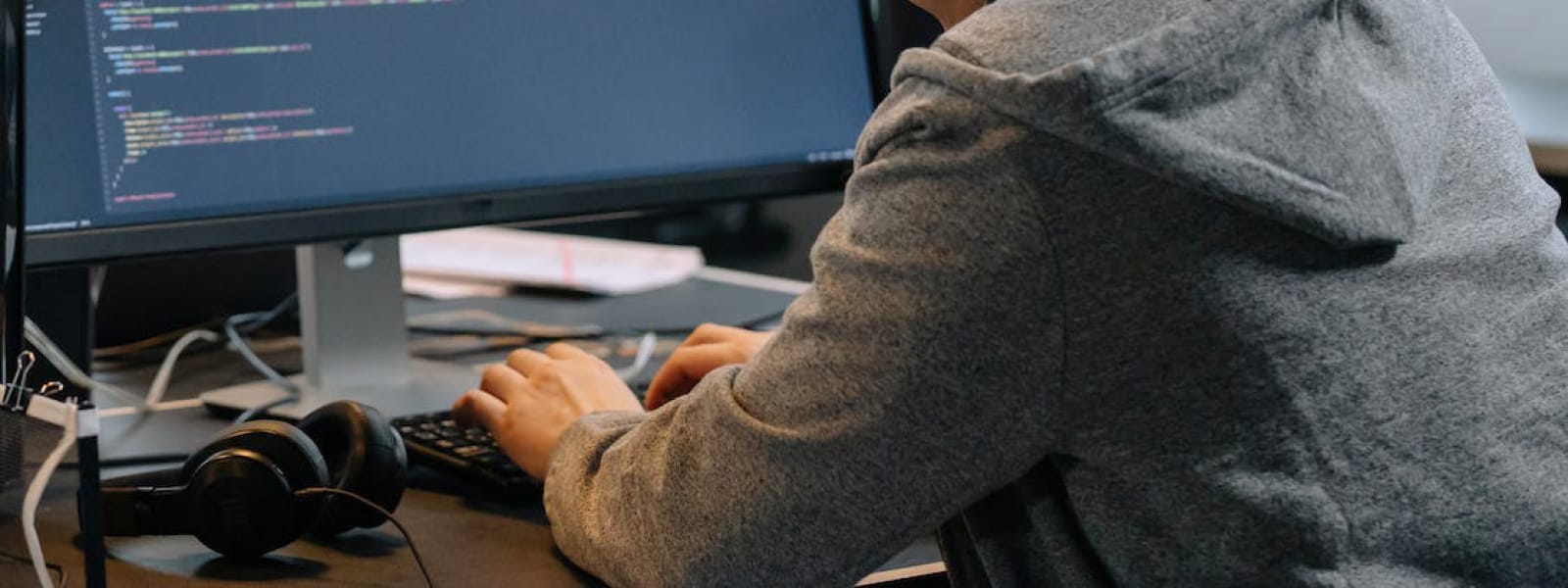 A student coding on a computer. 