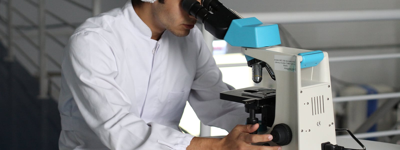 A man looks into a microscope.