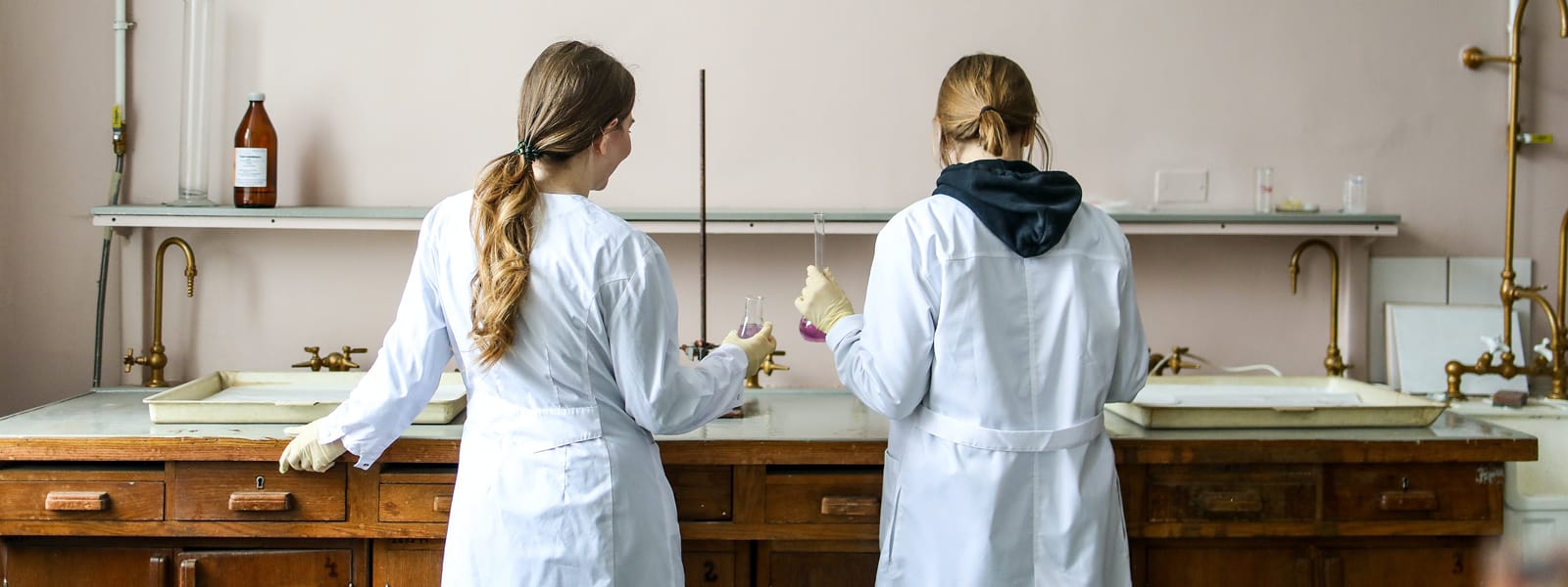 Two students work on a project in a chemistry classroom.