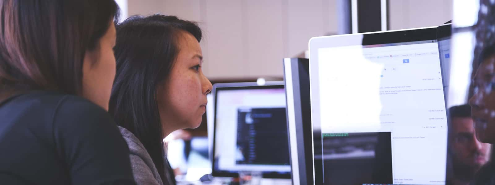 Two people looking at a computer screen.