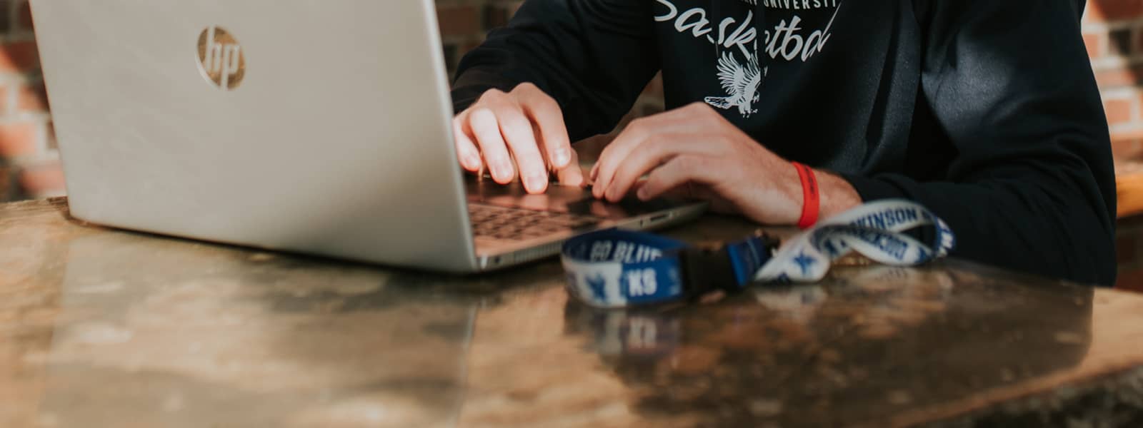 A student is typing on a laptop