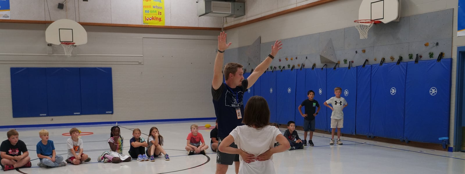 A man teaches young people exercise techniques.