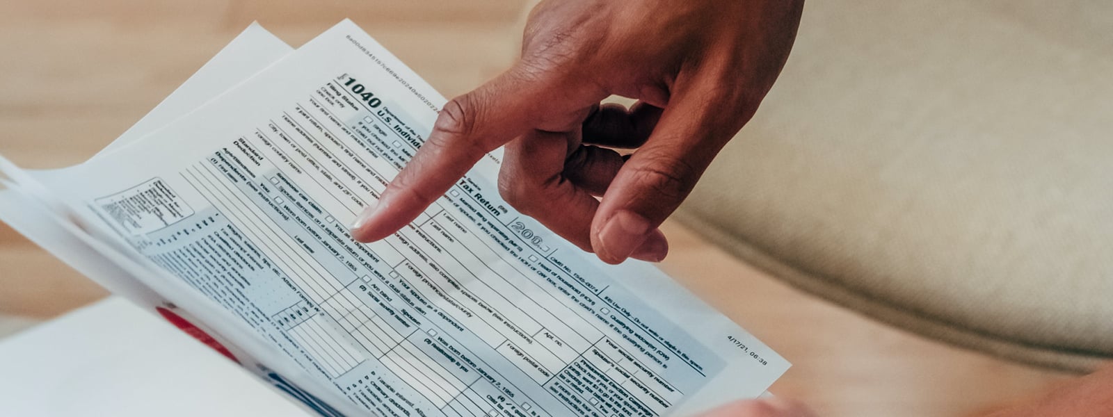 A person pointing to a tax form.