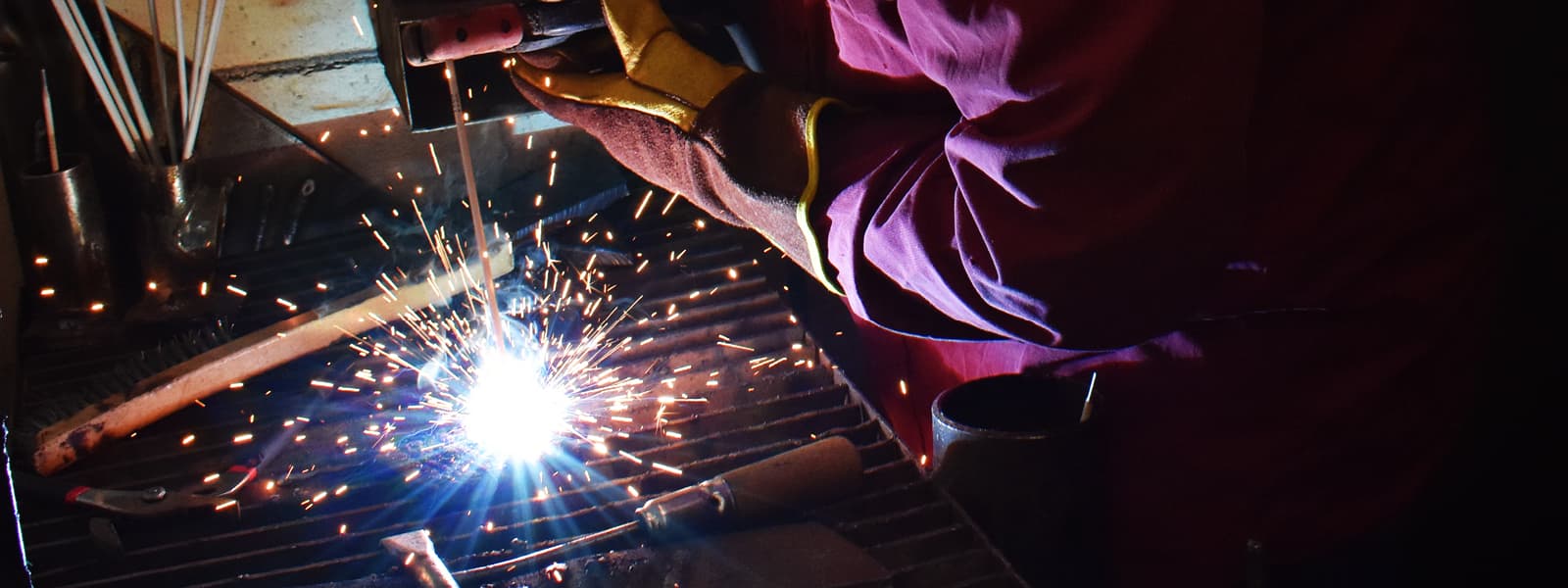 A student welding with sparks flying.