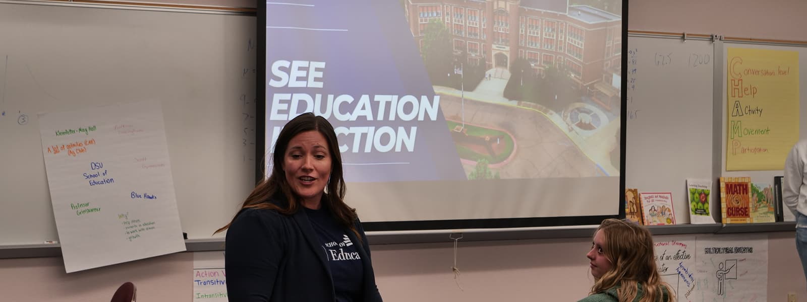 A professor giving a presentation to students. 